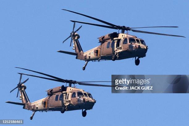 Israeli Air Force UH-60 Black Hawk helicopters fly over during an air show in Tel Aviv on April 26 as Israel marks Independence Day , 75 years since...
