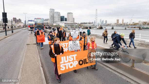 Just Stop Oil demonstrators stage a protest on Waterloo Bridge on April 26, 2023 in London, England.