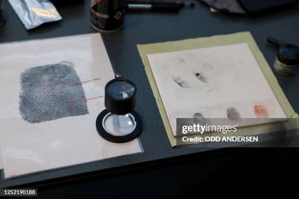 German Chancellor Olaf Scholz has his fingerprint taken by a student as he visits the stand of the Federal Police during the annual Girls' Day event...