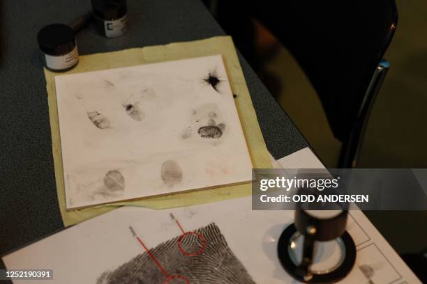 German Chancellor Olaf Scholz has his fingerprint taken by a student as he visits the stand of the Federal Police during the annual Girls' Day event...