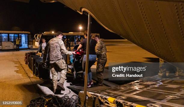 In this handout image provided by the Ministry of Defence, Image of British Nationals safely departing an RAF aircraft, after being evacuated from...