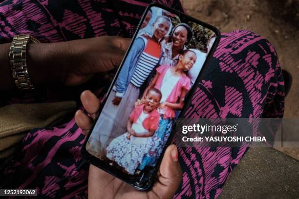 Bethy Kahindi shows a picture on her phone of three of six daughters of her 45-year-old sister as she looks for their bodies at the morgue of Malindi...