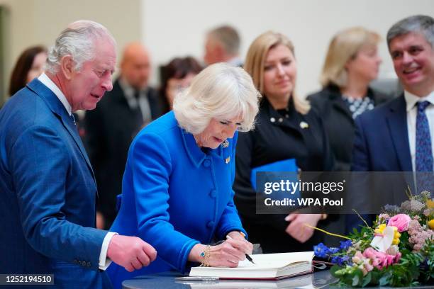 Britain's King Charles III and Camilla, the Queen Consort sign the guestbook as they visit Liverpool Central Library, to officially mark the...