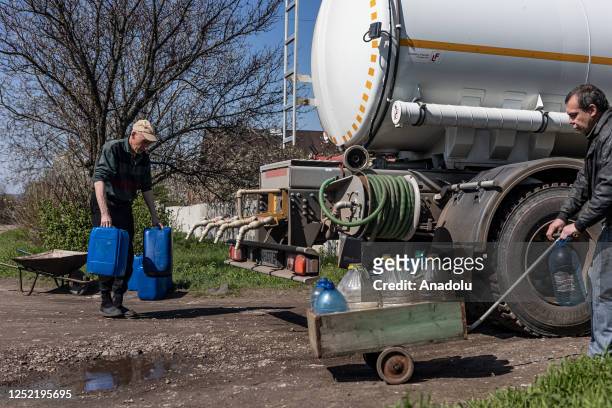 Citizens living in Kostiantynivka fill water to water bottles and buckets from a Ukrainian Emergency Service water tanker, which travels through the...