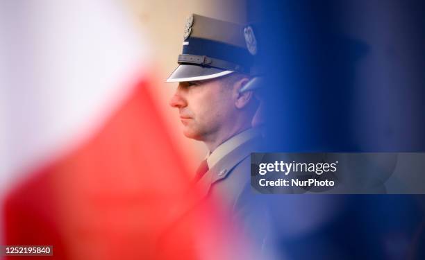 Member of the Polish Armed Forces is seen with Polish and NATO flags at the Palace on the Isle in Warsaw, Poland on 26 April, 2023. The Bucharest...