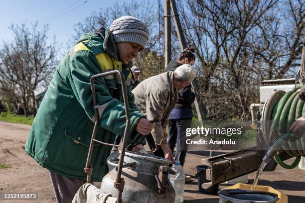 Citizens living in Kostiantynivka fill water to water bottles and buckets from a Ukrainian Emergency Service water tanker, which travels through the...