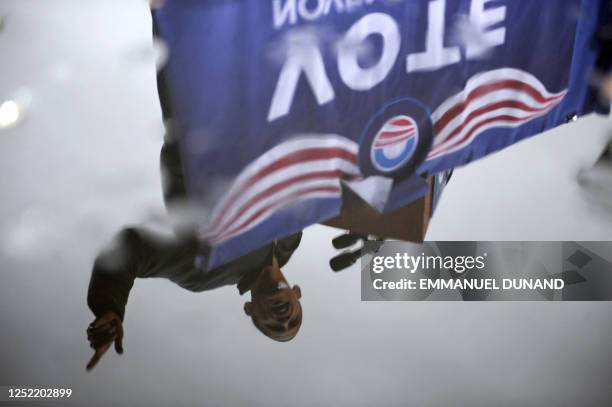 Democratic presidential candidate Illinois Senator Barack Obama is reflected in a rain puddle while speaking during a rally at Widener University in...