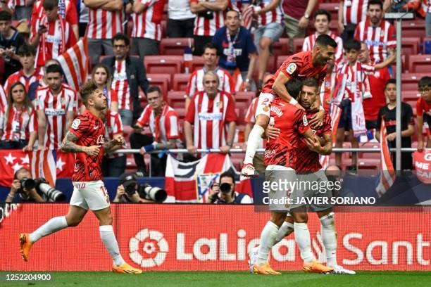Real Mallorca's Serbian defender Matija Nastasic celebrates with teammates after scoring his team's first goal during the Spanish league football...