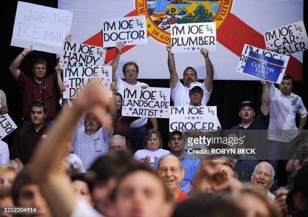 Supporters of Republican presidential candidate John McCain hold "Joe the Plumber" signs as another supporter makes a thumbs down gesture as McCain...