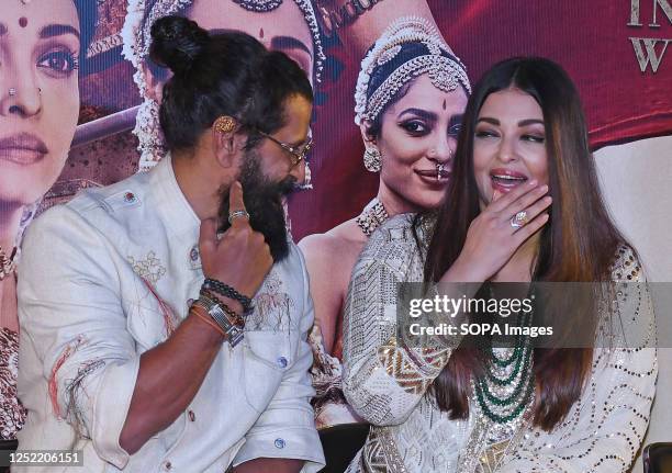 Indian film actor and playback singer Vikram and Bollywood actress Aishwarya Rai Bachchan share a candid moment during the press conference of their...