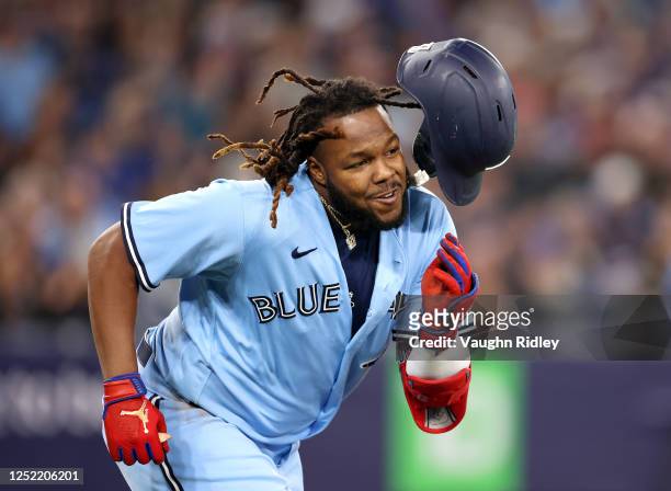 Vladimir Guerrero Jr. #27 of the Toronto Blue Jays loses his helmet after hitting a two-run double in the third inning against the Chicago White Sox...