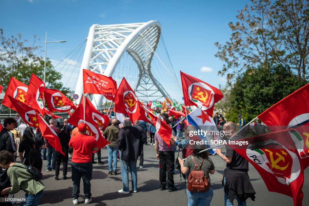 Protesters wave the red flags of the Italian Communist Party before