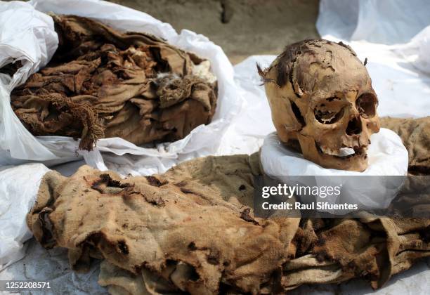 The skull and clothes of a mummy are displayed after being founded at Cajamarquilla archeological site, in the outskirts of the Peruvian capital on...