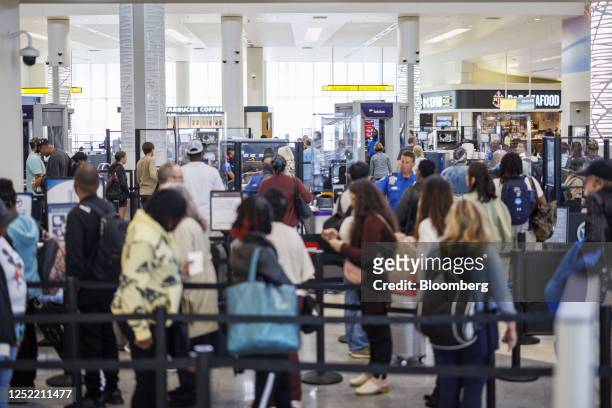 Departing travelers wait at a Transportation Security Administration security checkpoint at Baltimore-Washington Airport in Baltimore, Maryland, US,...