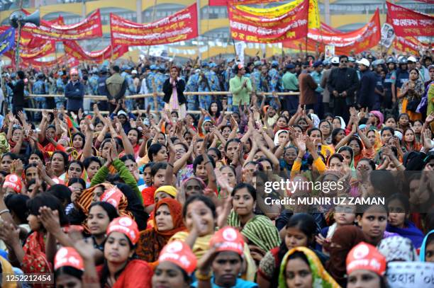 Bangladeshi supporters applaud unseen Awami League party leader Sheikh Hasina Wajed during an election campaign rally in Dhaka on December 26, 2008....