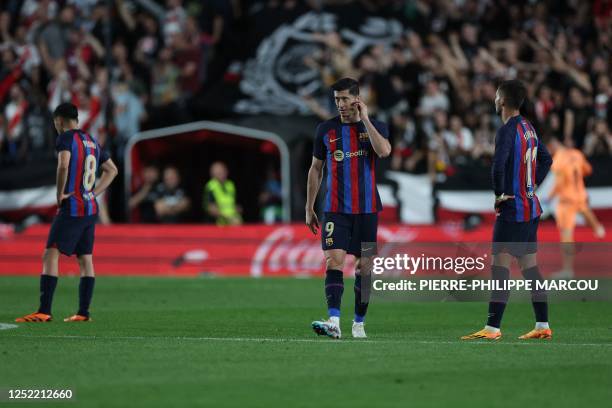 Barcelona's Polish forward Robert Lewandowski and teammates react during the Spanish league football match between Rayo Vallecano de Madrid and FC...