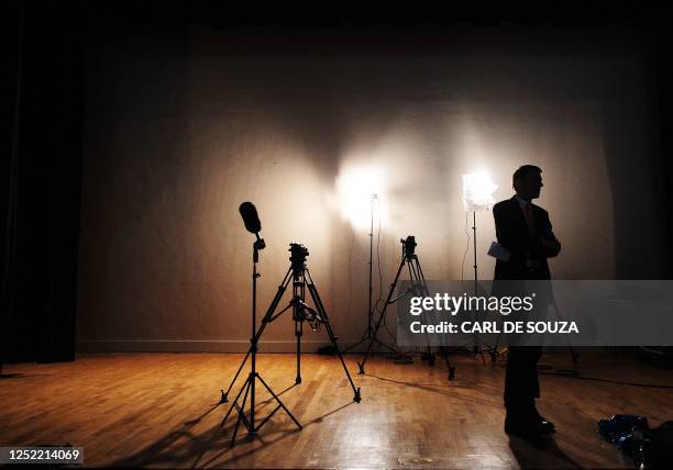 News presenter waits for Conservative Party Leader David Cameron at a campaign event on May 3, 2010 in Feltham, West London. Britain's party leaders...