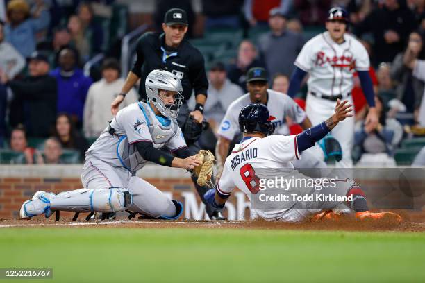 Eddie Rosario of the Atlanta Braves is tagged out at home by Jacob Stallings of the Miami Marlins during the sixth inning at Truist Park on April 26,...