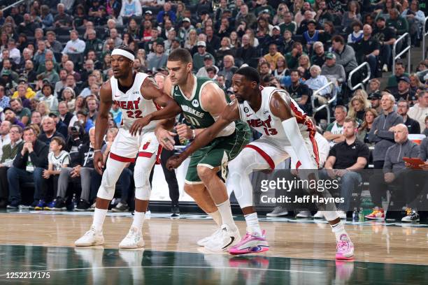 Jimmy Butler and Bam Adebayo of the Miami Heat box out Brook Lopez of the Milwaukee Bucks during Round 1 Game 5 of the 2023 NBA Playoffs on April 26,...