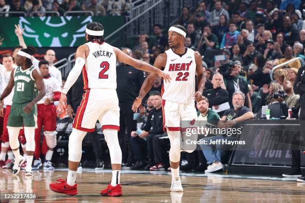 Gabe Vincent of the Miami Heat high fives Jimmy Butler during the game against the Milwaukee Bucks during Round 1 Game 5 of the 2023 NBA Playoffs on...