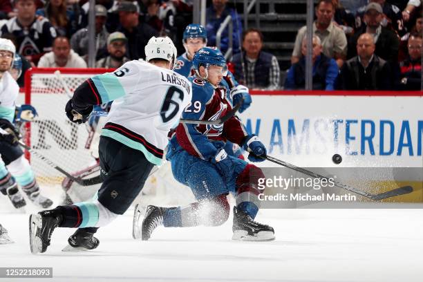 Nathan MacKinnon of the Colorado Avalanche blocks a shot by Adam Larsson of the Seattle Kraken in Game Five of the First Round of the 2023 Stanley...