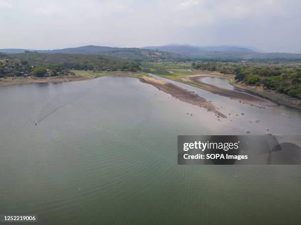 Aerial view of lake Guija. Lake Guija is a binational lake that feeds the Lempa River, the largest in the region. Habitants warn if water levels...