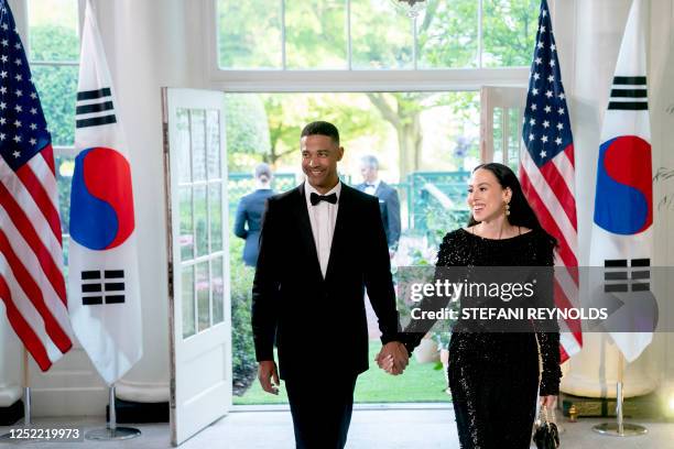 Nikolas Ajagu, Global Head of Partnerships at Facebook, Inc., and Meena Harris arrive for the State Dinner in honor of South Korean President Yoon...