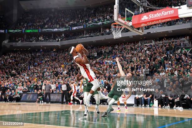 Jimmy Butler of the Miami Heat scores the game-tying basket at the end of the fourth quarter against the Milwaukee Bucks during Round 1 Game 5 of the...