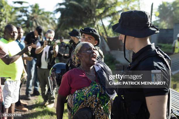 Woman yells to a French gendarme during the demolition of an informal settlement in Longoni, Mamoudzou, on the island of Mayotte on April 27, 2023.