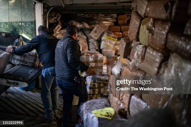 Officials from Mexico's attorney general's office unload hundreds of pounds of fentanyl and meth seized near Ensenada in October at their headquarter...