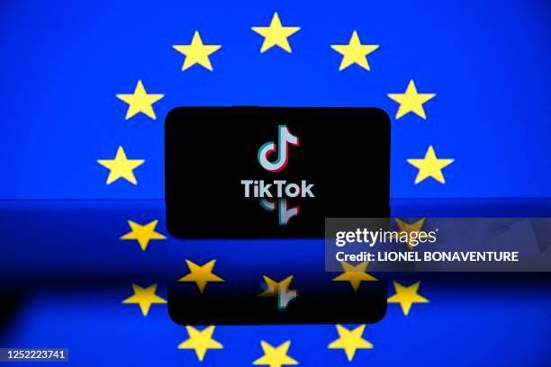 This picture taken on April 26, 2023 in Toulouse, southwestern France, shows a screen displaying the Tiktok social media platform's logo and the...