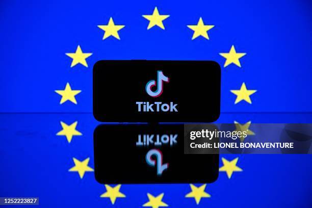 This picture taken on April 26, 2023 in Toulouse, southwestern France, shows a screen displaying the Tiktok social media platform's logo and the...