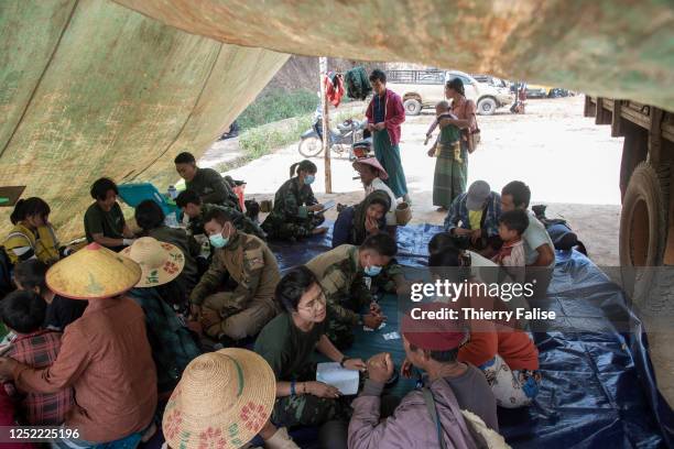 Team of medics from the relief group Free Burma Rangers examines a man in an Internally Displaced People settlement. Since the February 2021 military...