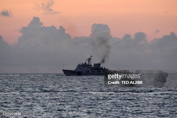 This photo taken on April 23, 2023 shows a Chinese coast guard ship patrolling as seen from Philippine coast guard vessel BRP Malabrigo at Second...
