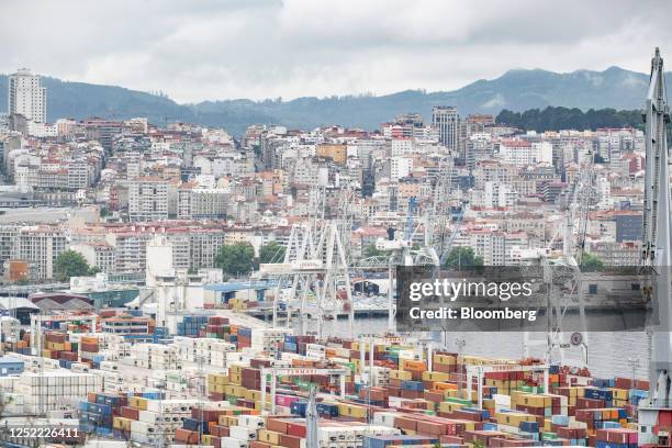 Residential apartment blocks beyond shipping containers and cranes at the Port of Vigo in Vigo, Spain, on Wednesday, April 26, 2023. Spain reports...