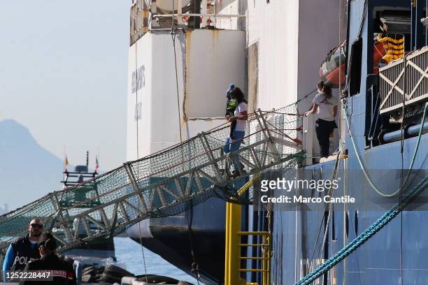Migrant child, carried in the arms of a rescuer, disembarks in Naples, from the Geo Barents rescue ship, after being saved from a shipwreck in the...