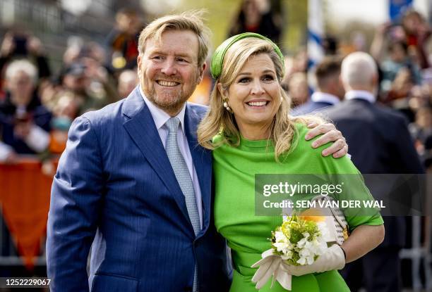 Netherlands' King Willem-Alexander embraces Queen Maxima during the celebration of King's Day in Rotterdam on April 27 which marks the tenth...
