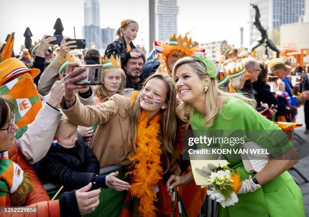 Netherlands' Queen Maxima poses for a 'selfie' during the celebration of King's Day in Rotterdam on April 27 which marks the tenth anniversary of...