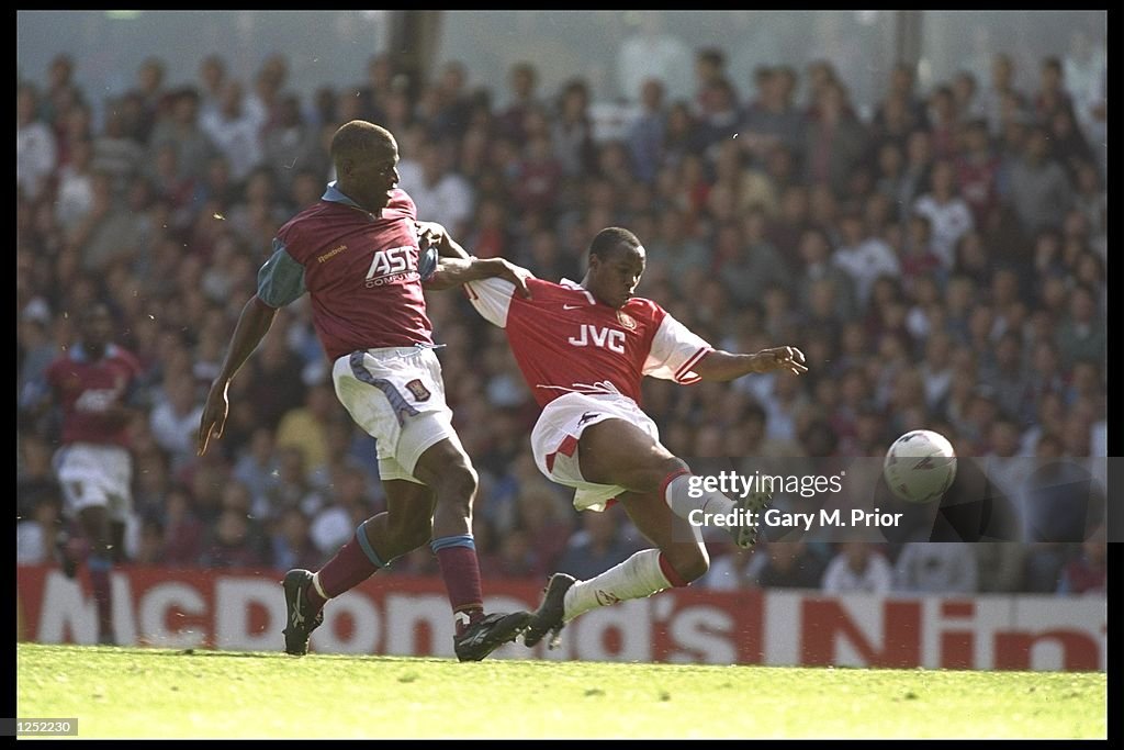 Ian Wright of Arsenal gets to the ball first