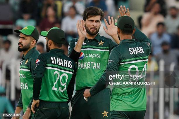 Pakistan's Shaheen Shah Afridi celebrates with teammates after taking the wicket of New Zealand's captain Tom Latham during the first one-day...