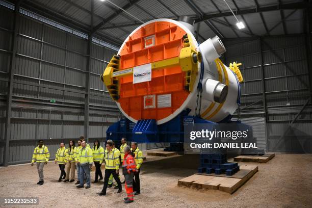 Staff stand below a nuclear reactor build by framatome, during a visit to Hinkley Point C nuclear power station near Bridgwater in south-west...