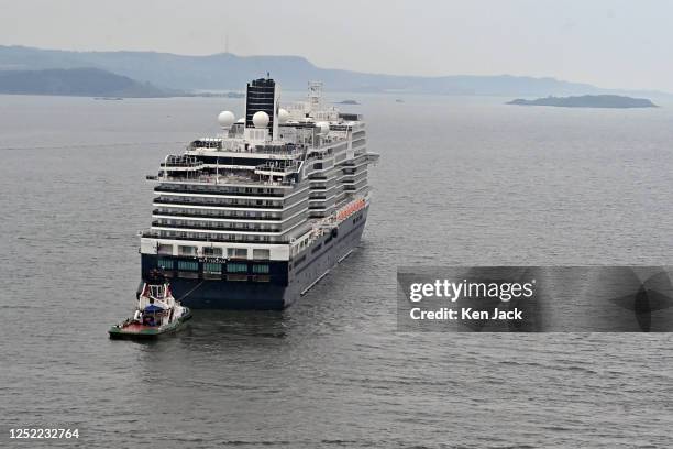 The first large cruise ship of the season to anchor in the upper Forth, the Holland America Line's MV Rotterdam, lies beside the Forth Bridge, on...