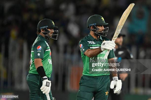 Pakistan's Fakhar Zaman celebrates after scoring half century as teammate Imam-ul-Haq watches during the first one-day international cricket match...