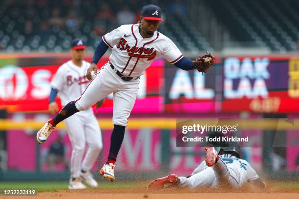 Jazz Chisholm Jr. #2 of the Miami Marlins steals second base under Ozzie Albies of the Atlanta Braves during the first inning at Truist Park on April...