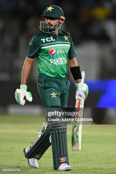 Pakistan's captain Babar Azam walks back to pavilion after his dismissal during the first one-day international cricket match between Pakistan and...