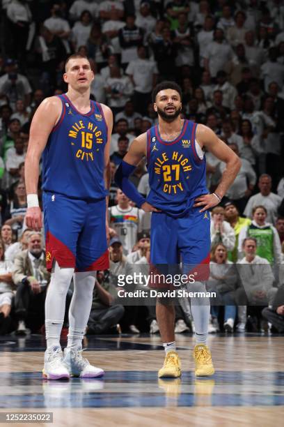 Nikola Jokic and Jamal Murray of the Denver Nuggets looks on during the game against the Minnesota Timberwolves during Round One Game Three of the...