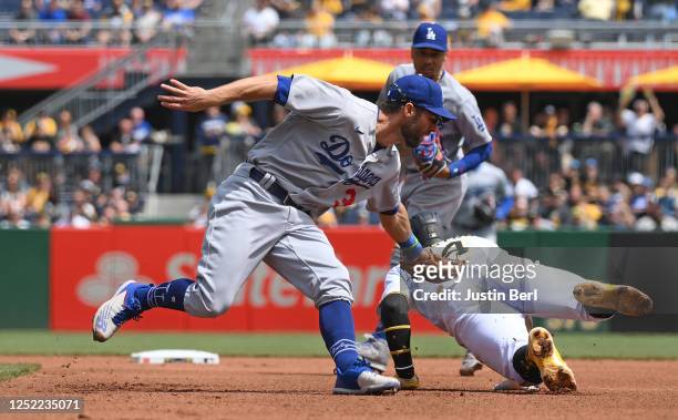 Rodolfo Castro of the Pittsburgh Pirates is tagged out by Chris Taylor of the Los Angeles Dodgers while attempting to steal second base in the fourth...