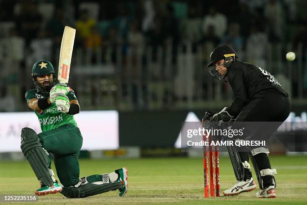 Pakistan's Mohammad Rizwan plays a shot as New Zealan's wicketkeeper captain Tom Latham watches during the first one-day international cricket match...