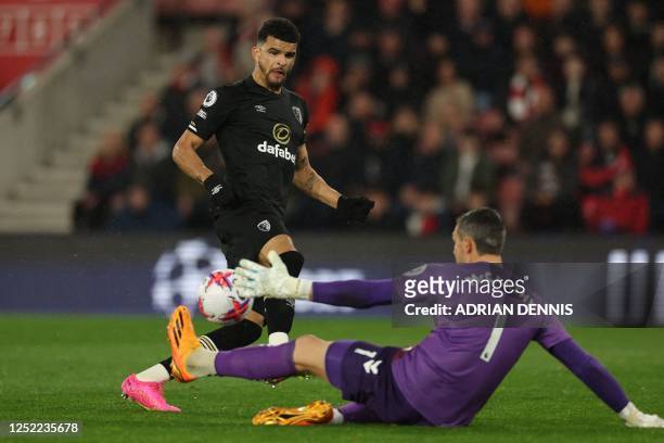 Southampton's English goalkeeper Alex McCarthy saves a shot from Bournemouth's English striker Dominic Solanke during the English Premier League...