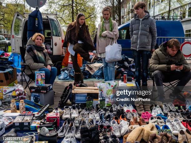 People are seen buying all kinds of things in one of the free markets placed in Amsterdam, during the celebration of King's Day on April 27th, 2023.